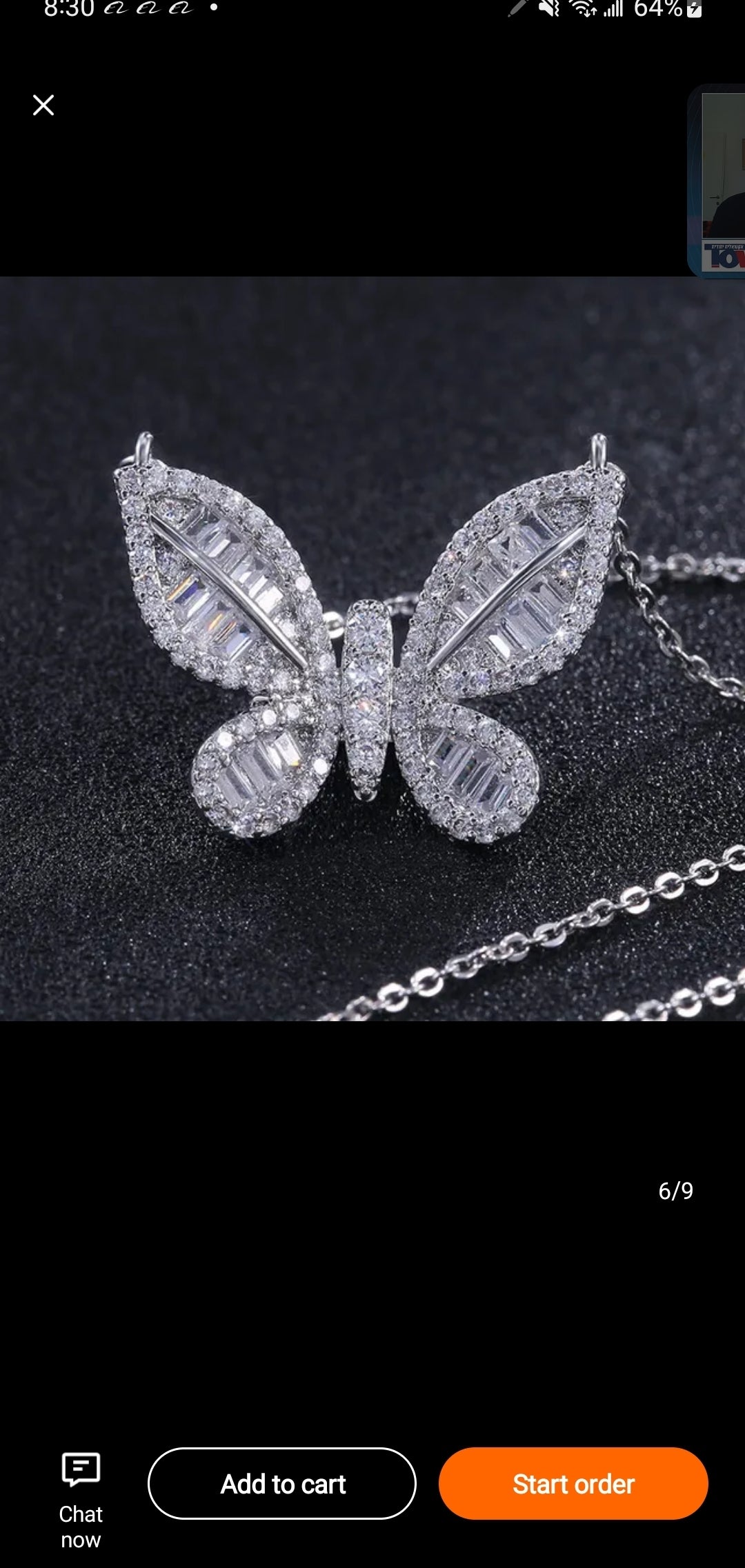 The Zirconmania Fashion Jewelry Baguette Set Butterfly Pendant Necklace 826P069-18 features a sparkling butterfly with baguette cubic zirconia on a silver chain, shown on a black background.