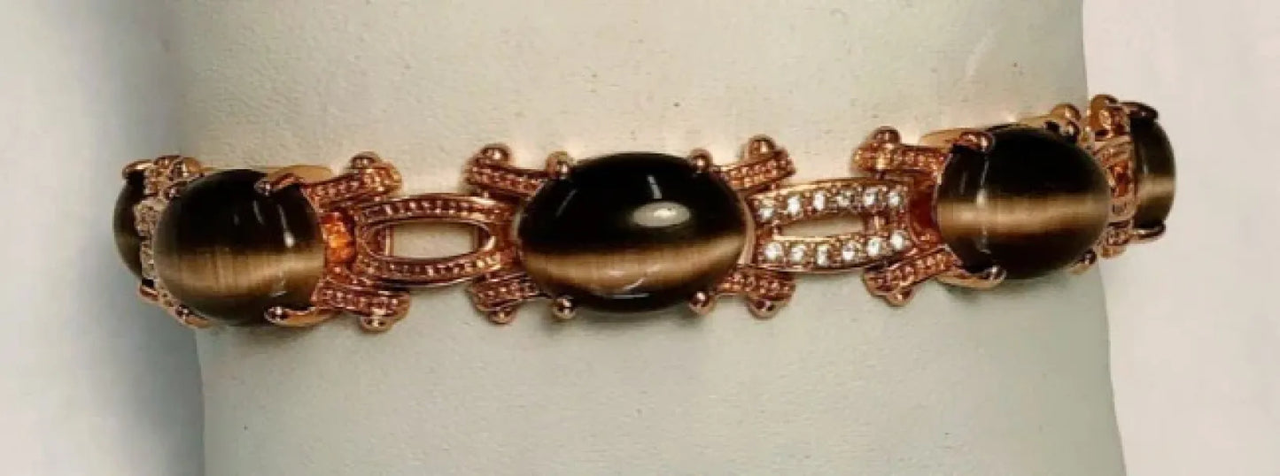 The DiamondVeneer Fashion Cats Eye Oval Cabochon set w/Zirconite Cubic Zirconia Bracelet 501B097 features large cats eye cabochons and sparkling zirconias in ornate 18K gold-plated links, shown on a light background.