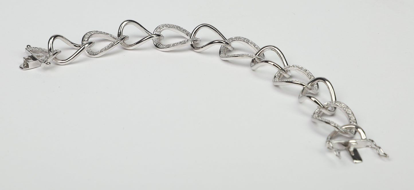 The DiamondVeneer Fashion Large Curved Link Zirconite Cubic Zirconia Sterling Silver Bracelet (STB599) features interlocking heart-shaped and curved links, some accented with sparkling cubic zirconia, shown on a plain white background.