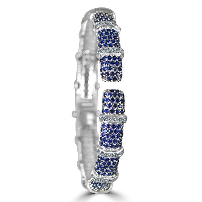 The DiamondVeneer Fashion Face-off Zirconite Cubic Zirconia Hinged Bangle Bracelet 698B10CZ showcases alternating blue and white stones in rounded segments with sparkling, intricate detailing.
