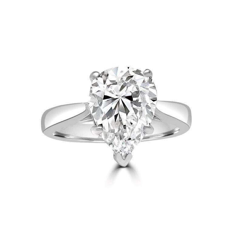 The DiamondVeneer Fashion Pear Solitaire Diamond Veneer Cubic Zirconia 14K Gold Ring (635R003K) features a striking pear-shaped stone set on a sleek gold band, beautifully displayed on a white background.