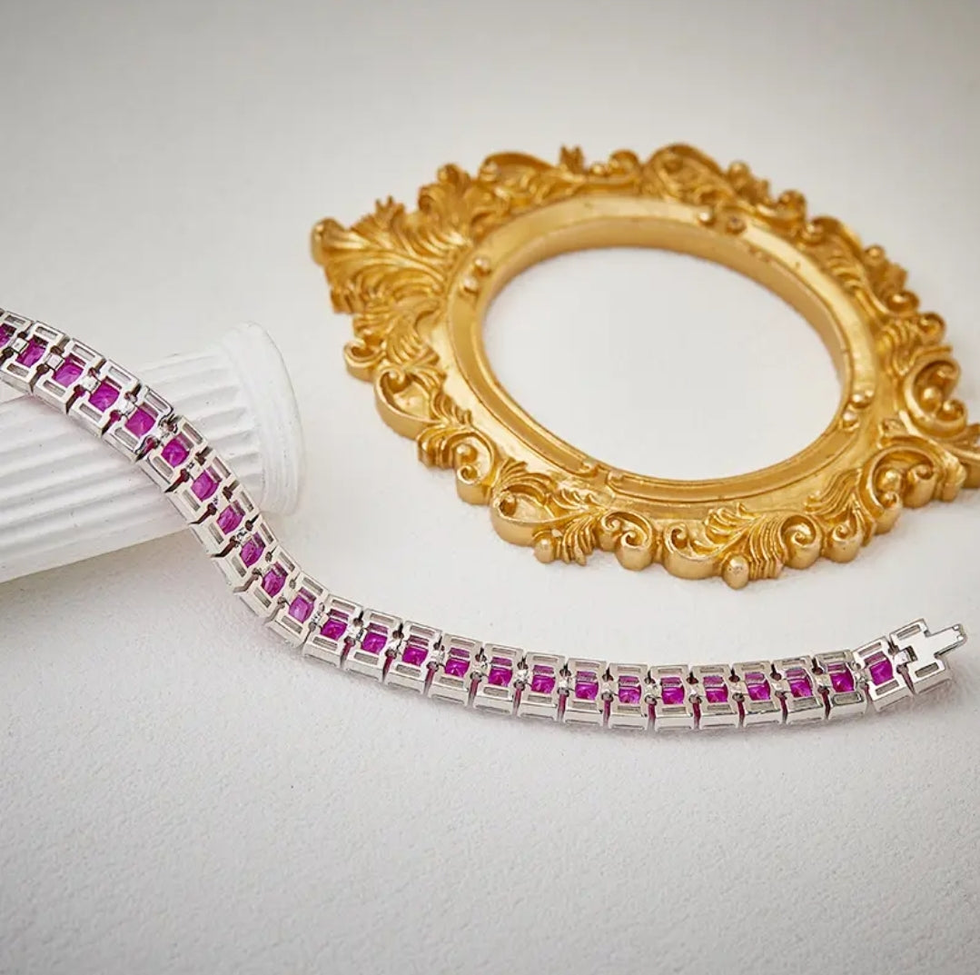 Zirconmania bracelet features baguette and cushion-cut pink zirconite stones, showcasing a unique, elegant tennis design.