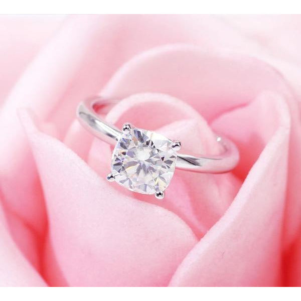 The DiamondVeneer Fashion Round Diamond Veneer Cubic Zirconia Solitaire 14K Gold Ring (635R208A-K) is shown atop soft pink rose petals.