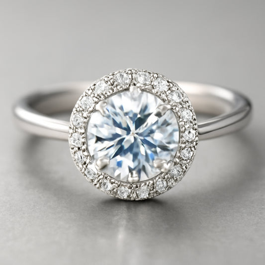 A close‑up of a halo ring set in sterling silver, reflecting light in a studio setting. Alt: Halo ring sparkle