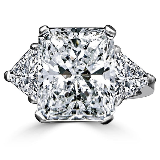 The DiamondVeneer Fashion 10CT Diamond Veneer Cubic Zirconia Three Stone 14K Gold Ring showcases a radiant-cut center stone with two triangular side stones, echoing the brilliance of high-end designs.