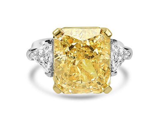 The DiamondVeneer Fashion Three Stones Cubic Zirconia Engagement Ring (803R100) features a radiant-cut yellow center stone with two triangular white side stones, set in sterling silver with yellow gold prongs for a stunning modern look.