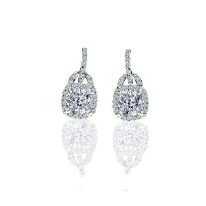 The DiamondVeneer Fashion 2CT TW Cushion Square Diamond Veneer Cubic Zirconia Sterling Silver Earrings (635E15751) feature cushion-cut stones with a halo of smaller accents on diamond-encrusted hooks, displayed against a white background.
