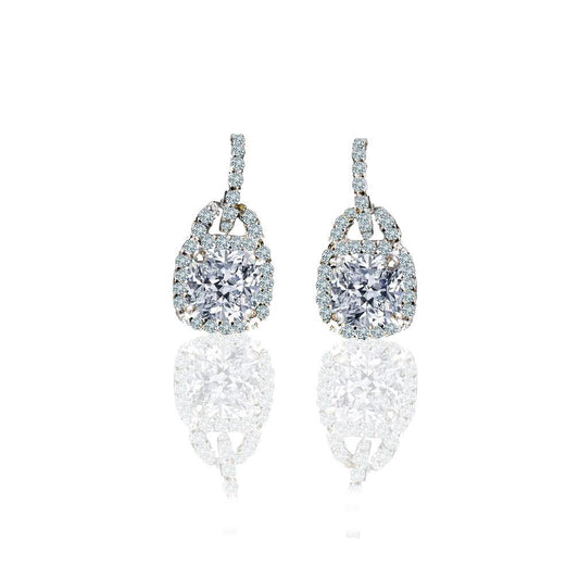 The DiamondVeneer Fashion 2CT TW Cushion Square Diamond Veneer Cubic Zirconia Sterling Silver Earrings (635E15751) feature cushion-cut stones with a halo of smaller accents on diamond-encrusted hooks, displayed against a white background.