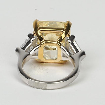 A close-up of the DiamondVeneer Fashion Three Stones Cubic Zirconia Engagement Ring (803R100), featuring a two-tone sterling silver band with a large rectangular yellow stone in a gold setting and two smaller clear stones from the back view.