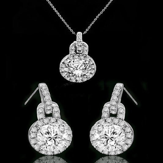 The DiamondVeneer Fashion Round Diamond Veneer Cubic Zirconia Sterling Silver Halo Pendant and Earrings Set (635P10732/635E3234) features a sparkling pendant necklace and matching earrings with center stones surrounded by halos.