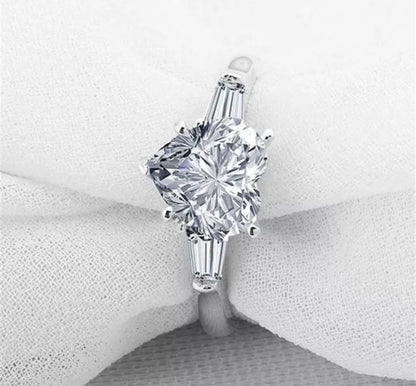 The DiamondVeneer Fashion 5CT Heart Cubic Zirconia Ring (635R71352) features a stunning heart-shaped center stone and is displayed on a soft white fabric background.