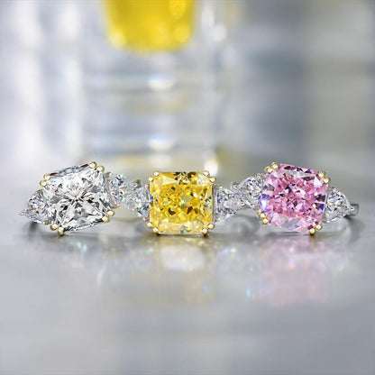 The Three Stones Square Cubic Zirconia Engagement Ring (801R9042) by DiamondVeneer Fashion features clear, yellow, and pink stones with smaller accents set in mixed metal bands, including sterling silver.