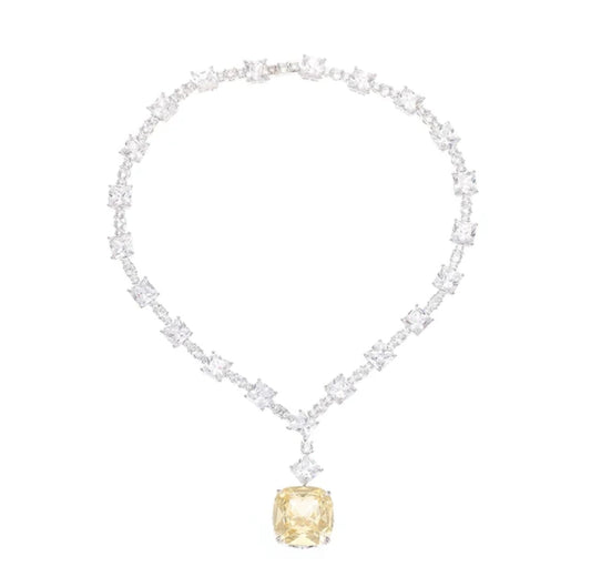 The DiamondVeneer Fashion 826N100 necklace features a cushion-cut yellow cubic zirconia pendant and clear white stones on a symmetrical chain, offering the look of fine diamonds.