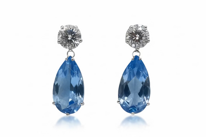 Luxury pear-cut CZ drop earrings by DiamondVeneer in blue, dark blue, pink, yellow & champagne. Elegant, eye-catching fashion jewelry.