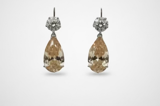 Luxury pear-cut CZ drop earrings by DiamondVeneer in blue, dark blue, pink, yellow & champagne. Elegant, eye-catching fashion jewelry.