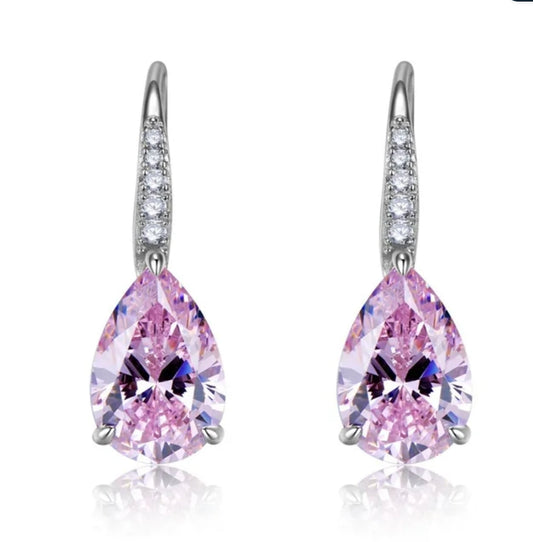 DiamondVeneer Fashion’s Cubic Zirconia Pear Earrings (851E2648) showcase large pink pear-shaped stones set in silver, accented with small round zirconite along the fish hooks for an elegant look.