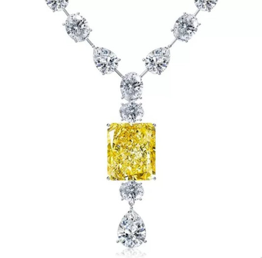 Make a statement with the DiamondVeneer Fashion Cubic Zirconia Statement Necklace Pendant 830N095, featuring round and pear-shaped white cubic zirconia, a radiant-cut yellow centerpiece, and a pear-shaped drop for added elegance.
