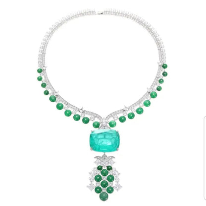 The DiamondVeneer Fashion Fusion Colombian Emerald Cubic Zirconia Necklace 840N105E showcases round green gems, a central rectangular emerald, and a pendant with green and white stones in an elegant, symmetrical design.