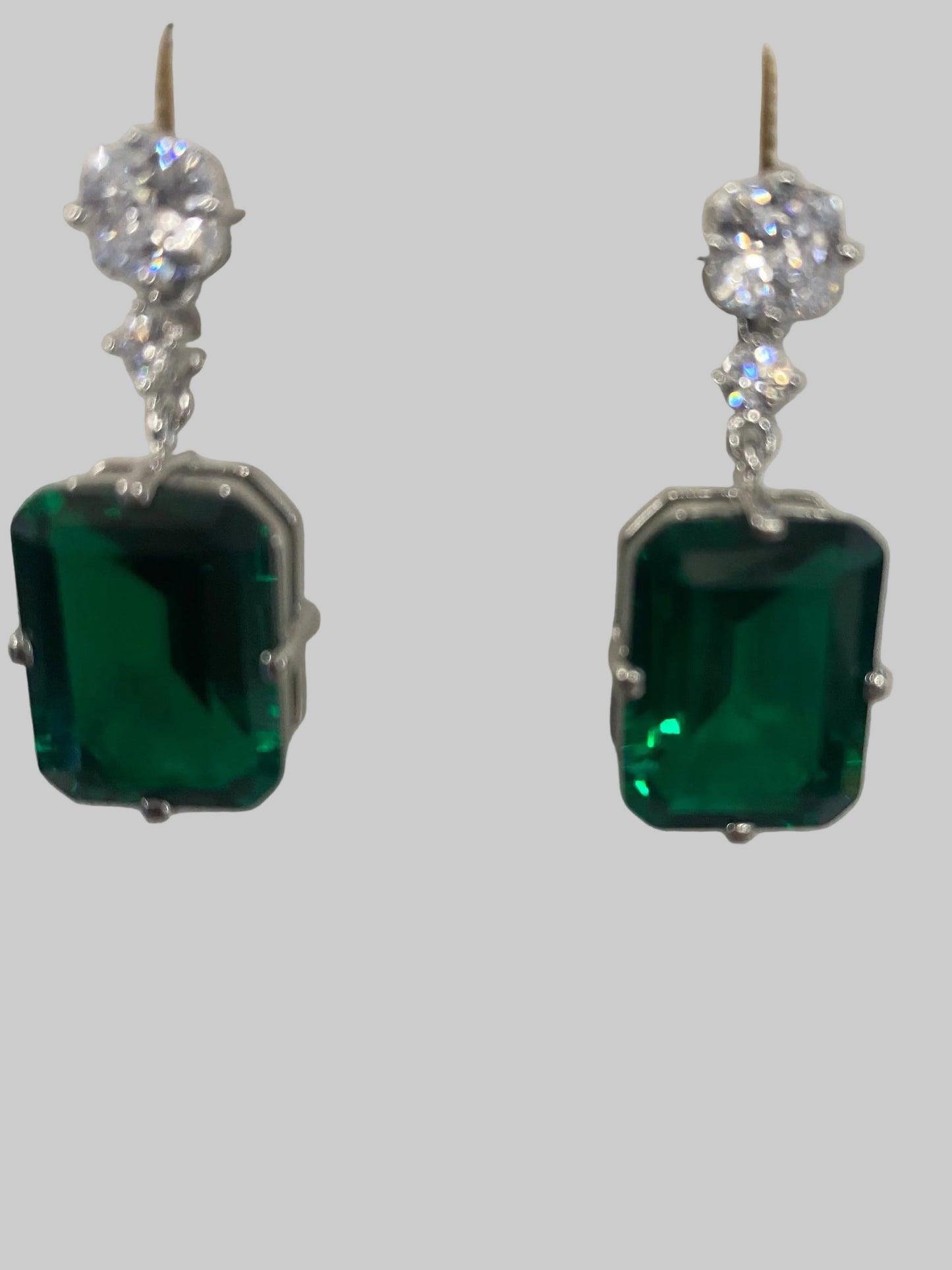 DiamondVeneer drop earrings, style 830E1033, feature elegant cubic zirconia in a modern design on a white display stand.