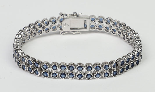 The DiamondVeneer Fashion AH3559 bracelet features two rows of color Zirconite cubic zirconia in a sterling silver setting with a double safety lock, shown in a closed loop on a plain white background.