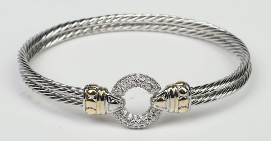 The DiamondVeneer Fashion Circle Zirconite Cubic Zirconia Pave Cable 2-tone Bangle Bracelet (500B3961) features gold-tone accents and a circular, pave-set centerpiece in a twisted design on a white background.