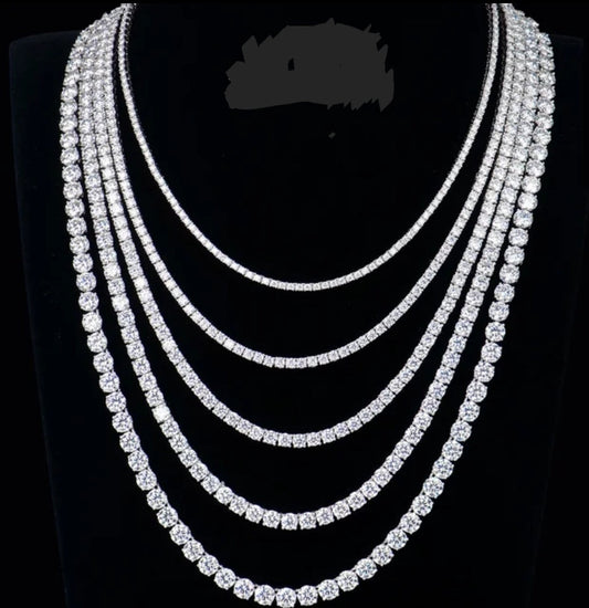 A black display bust showcases six Moissanite Lab Created Diamond Tennis Necklaces by DiamondVeneer Fashion (850N4MM), elegantly layered in graduated lengths—an eye-catching, sparkling alternative to traditional diamonds.