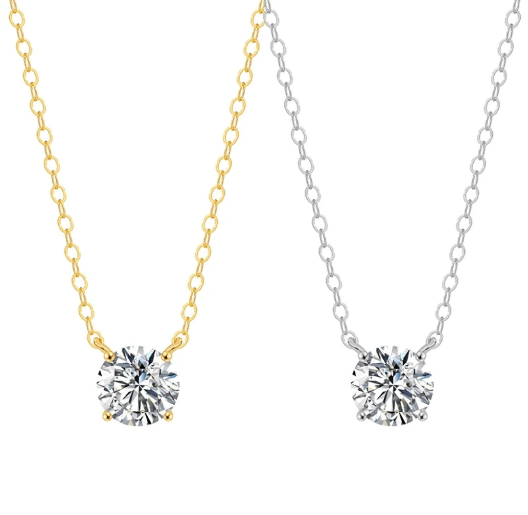 Two necklaces feature round cubic zirconia solitaire pendants by DiamondVeneer Fashion: one, the 14K Gold Round Cubic Zirconia Solitaire Pendant (Diamond Veneer 635P100Mk), is set on a gold chain; the other rests on a silver chain, both in classic elegant styles.