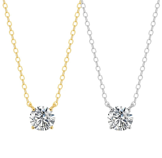 Two necklaces feature round cubic zirconia solitaire pendants by DiamondVeneer Fashion: one, the 14K Gold Round Cubic Zirconia Solitaire Pendant (Diamond Veneer 635P100Mk), is set on a gold chain; the other rests on a silver chain, both in classic elegant styles.