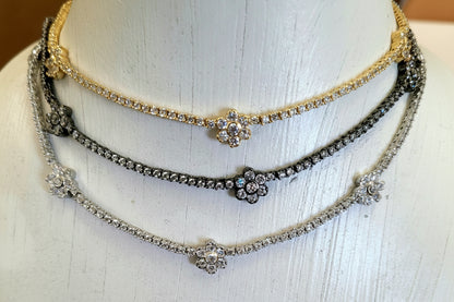 Woman wearing Zirconmania 925 silver necklace featuring cubic zirconia flower clusters—elegant design ideal for weddings or parties.