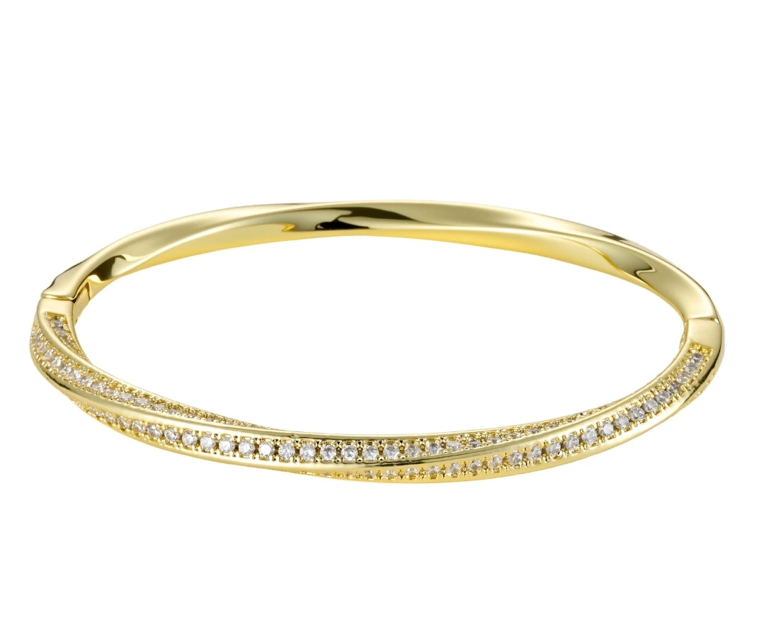The Twisted Gold Pavé CZ Bangle Bracelet by Zirconmania Fashion Jewelery features two parallel rows of sparkling CZ and a unique twisted design, making it a striking unisex luxury accessory for any occasion.