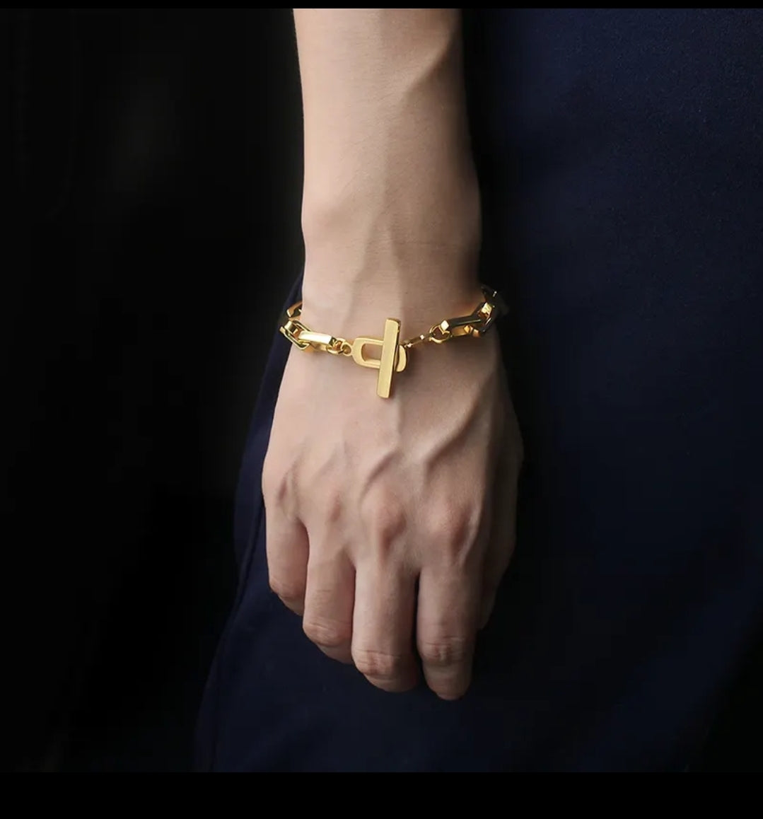 Zirconmania's unisex rectangular link bracelet features a sleek, modern chain design with a polished finish on a white backdrop.