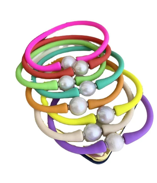 The DiamondVeneer Fashion Zirconite Pearl Rubber Bracelet Bangle (837B100) is a set of seven colorful bangles, each with a large freshwater pearl-like bead, in vibrant shades of pink, green, orange, yellow, cream, and purple.