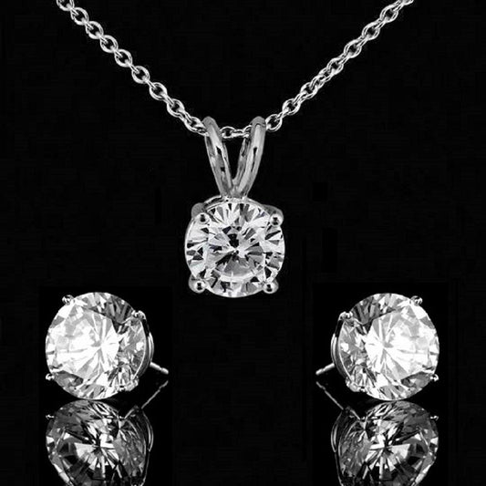 The Diamond Veneer Cubic Zirconia Sterling Silver Pendant and Earrings Set by DiamondVeneer Fashion features a round solitaire pendant and matching simulated diamond earrings, shown on a black background.