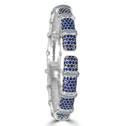 The DiamondVeneer Fashion Face-off Zirconite Cubic Zirconia Hinged Bangle Bracelet 698B10CZ showcases alternating blue and white stones in rounded segments with sparkling, intricate detailing.