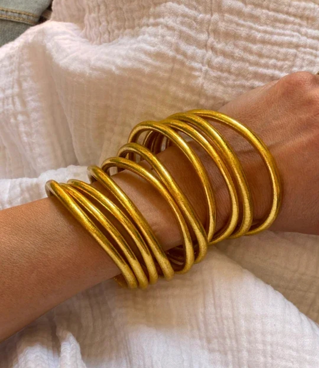 Gold silicone Buddhist temple bangle bracelet, worn on model, 859B100G