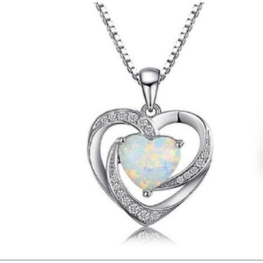 DiamondVeneer Fashions Lab Created Opal Heart Sterling Silver Pendant (714P0047) features a central opal heart, rhinestone accents, and a twisting silver design on a matching chain. Sales Special! Displayed against a white background.