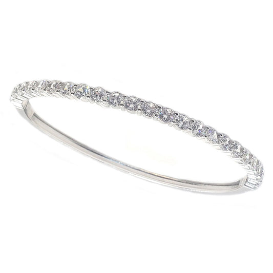 The DiamondVeneer Fashion 4mm Hinged Zirconite Cubic Zirconia Line Rhodium Bangle Bracelet (698B005) features a slim, elegant design with sparkling white stones set in a row, photographed on a plain white background.