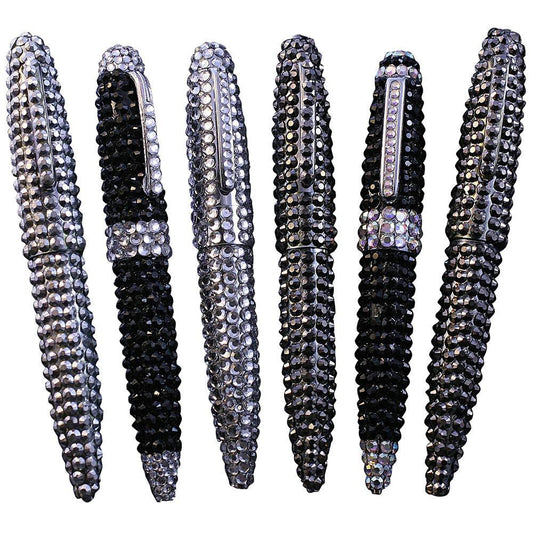 Six DiamondVeneer Fashion Jeweled Pens, adorned with alternating black and silver rhinestones, stand upright in a neat row against a white background.