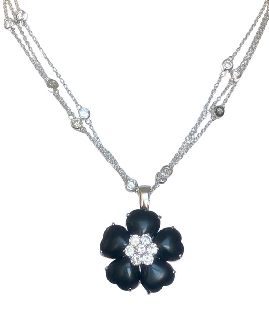 The DiamondVeneer Fashion Zirconite Cubic Zirconia w/Cats Eye Heart Flower Necklace (626P20011) features a silver chain, sparkling crystals, and a striking black flower pendant with a white crystal-accented center.