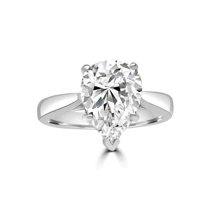 The DiamondVeneer Fashion Pear Solitaire Diamond Veneer Cubic Zirconia 14K Gold Ring (635R003K) features a striking pear-shaped stone set on a sleek gold band, beautifully displayed on a white background.
