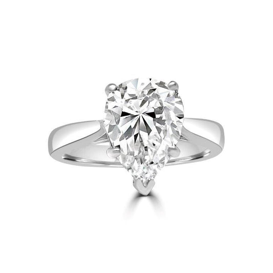 The DiamondVeneer Fashion Pear Solitaire Diamond Veneer Cubic Zirconia 14K Gold Ring (635R003K) features a striking pear-shaped stone set on a sleek gold band, beautifully displayed on a white background.
