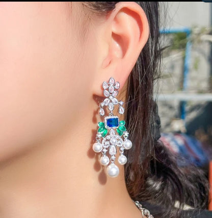 Whimsical pearl droplet chandelier earrings by Zirconite, worn on model, 826E0375