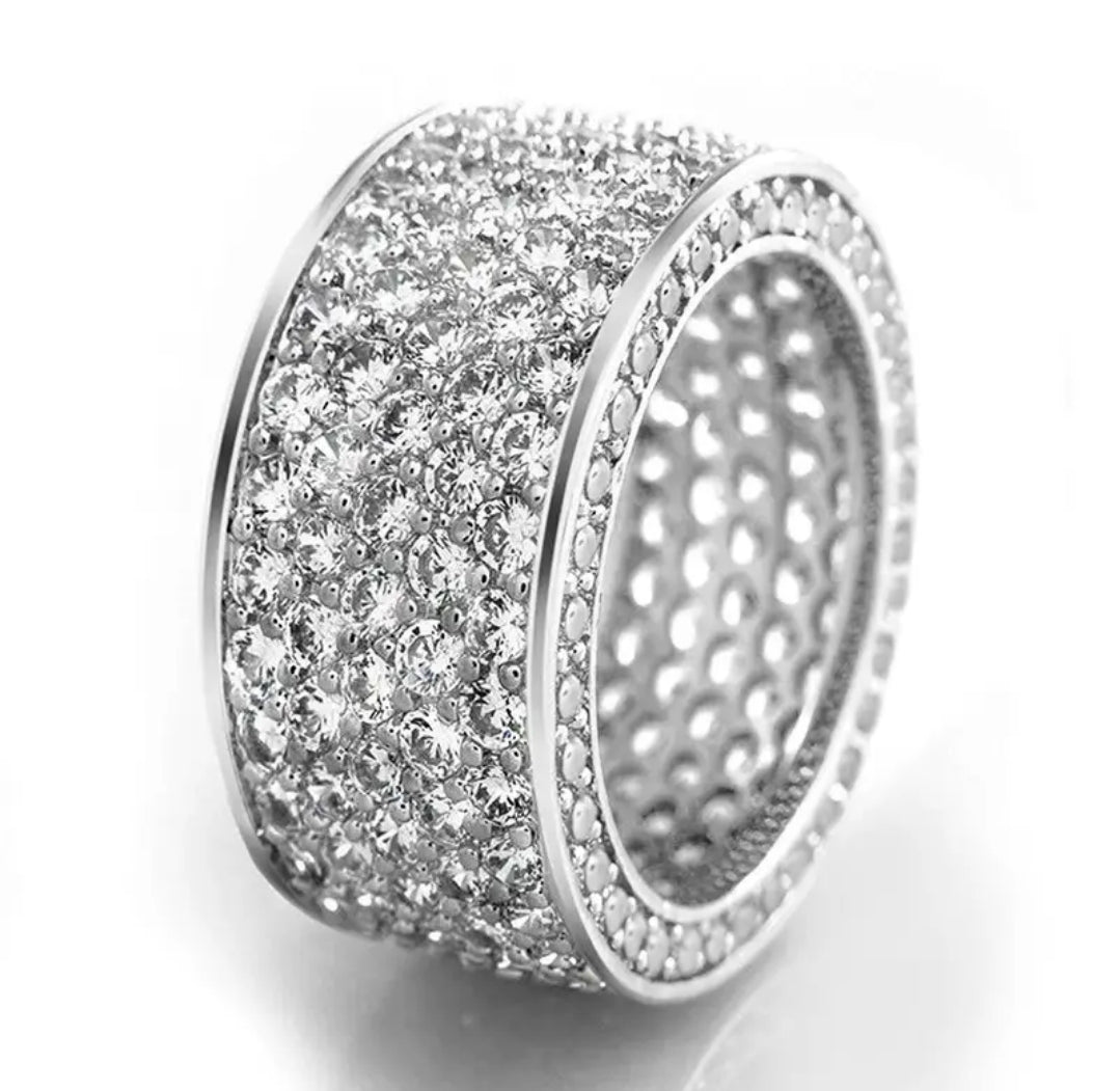 Zirconmania sterling silver eternity ring with pavé diamond simulants, multi-row band, shimmering on white background.