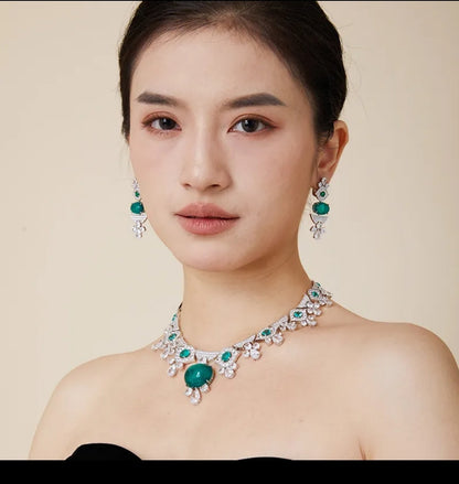 Woman in black strapless top wears Zirconmania’s Couture 840N110 set, featuring bold cabochon gems and sleek modern design.