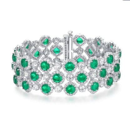 The DiamondVeneer Fashion Cubic Zirconia Couture Bracelet (Zirconite 826B100) dazzles with three rows of vivid green clusters and sparkling accents in an intricate silver design—ideal for lovers of luxurious statement jewelry.