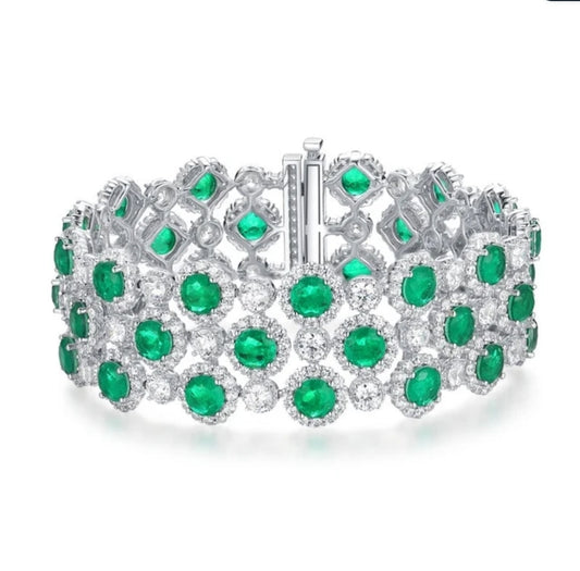 The DiamondVeneer Fashion Cubic Zirconia Couture Bracelet (Zirconite 826B100) dazzles with three rows of vivid green clusters and sparkling accents in an intricate silver design—ideal for lovers of luxurious statement jewelry.