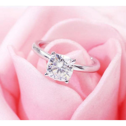 The DiamondVeneer Fashion Round Diamond Veneer Cubic Zirconia Solitaire 14K Gold Ring (635R208A-K) is shown atop soft pink rose petals.