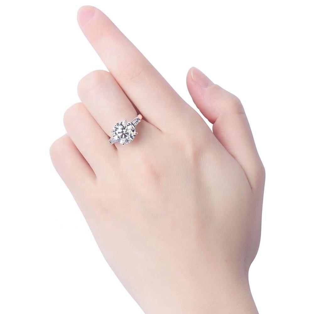 Round cubic zirconia solitaire ring with tapered baguettes - side angle
