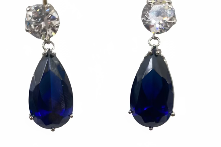 Luxury pear-cut CZ drop earrings by DiamondVeneer in blue, dark blue, pink, yellow & champagne. Elegant, eye-catching fashion jewelry.