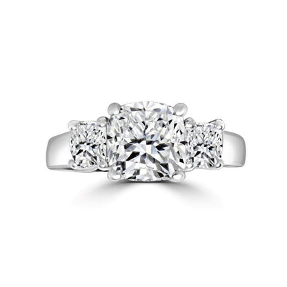 The DiamondVeneer Fashion Three Stone Cushion Diamond Veneer Cubic Zirconia 14K Gold Ring (635R0010K) features a cushion-cut center stone flanked by two round stones on a polished gold band.